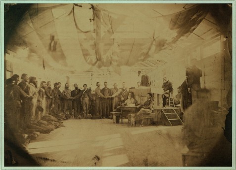 Prisoners at Point Lookout, MD taking the oath of allegiance. A group of prisoners stand in a building, with the U.S. Flag draped across the ceiling, each with his hand on a Bible. A Union officer stands at a dias administering the oath of allegiance to the Union. Image courtesy of Civil War Treasures from the New-York Historical Society, [Digital ID, nhnycw/ae ae00007] http://memory.loc.gov/ammem/ndlpcoop/nhihtml/cwnyhshome.html